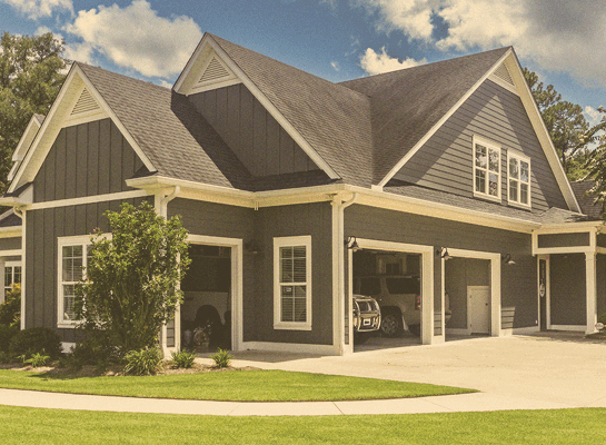 Beautiful suburban home with garage doors open appearing as an easy target for a burglary