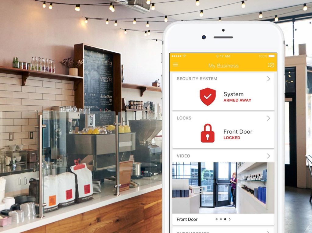 Coffee shop with a smartphone display of the Myemailnotifier mobile app for businesses.